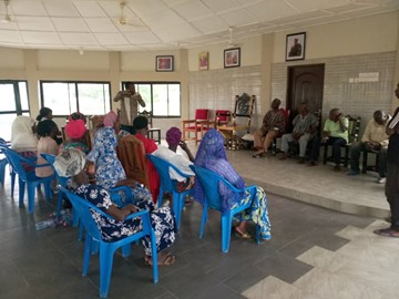 Community members seated in a meeting hall