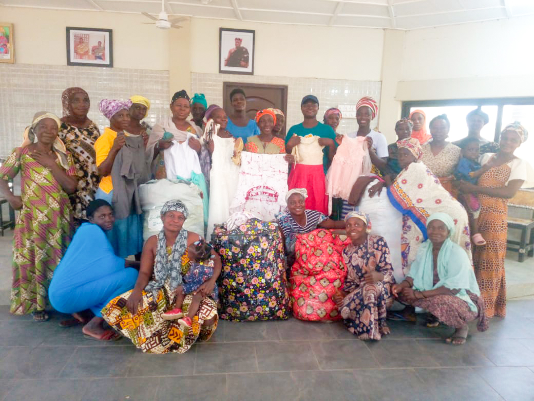 A group of women posing with donated clothing