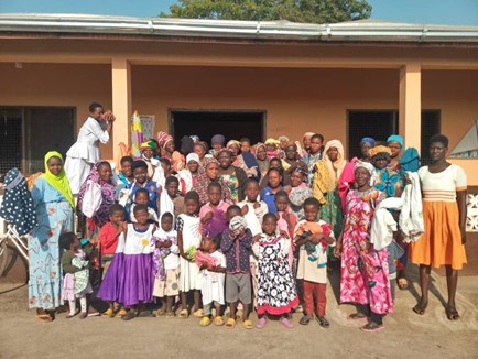 A large community group standing outdoors