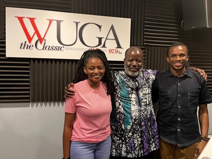 Three people standing together in a WUGA radio studio